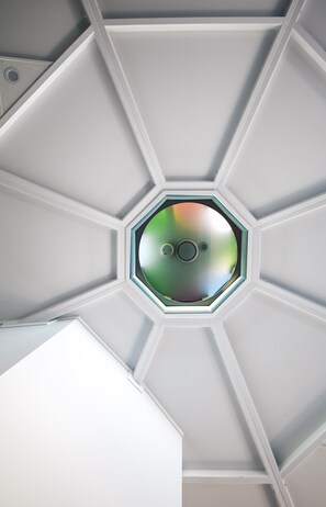 A ceiling with a hexagonal skylight.