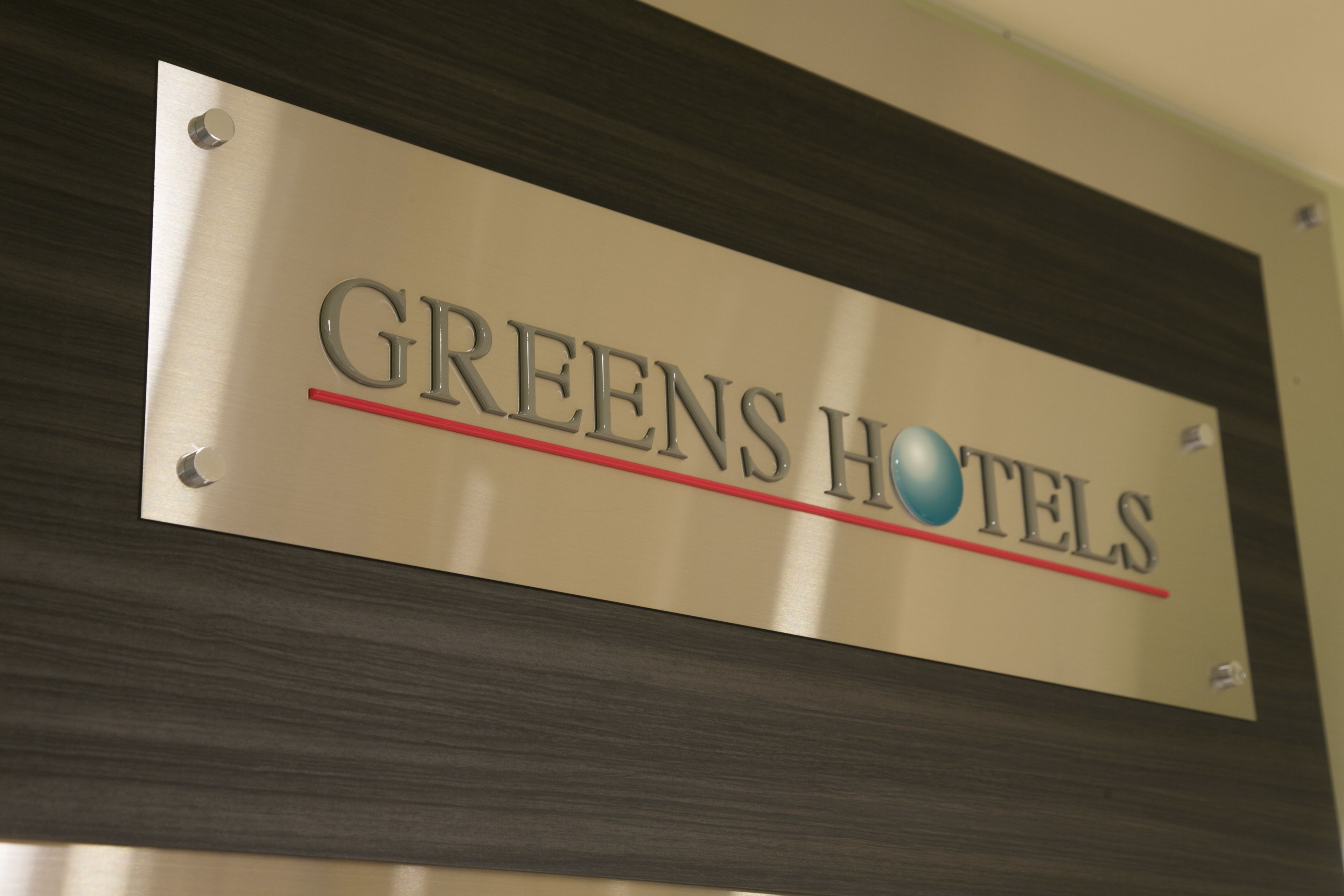 A sign for Greens Hotels.