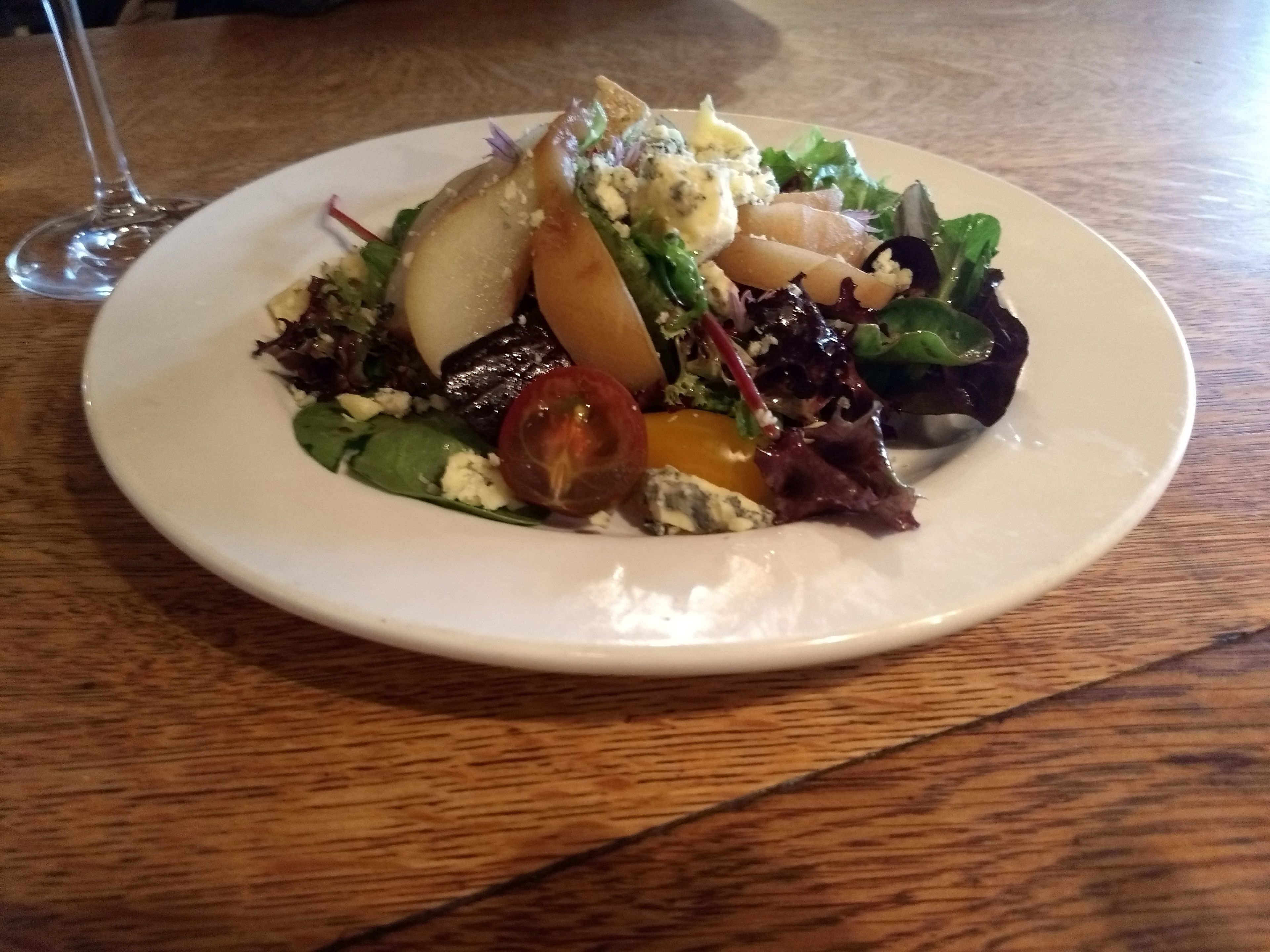 A plate of food on a wooden table.