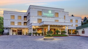 A modern hotel with a prominent 'lemon tree' sign, multiple floors, and a well-lit entrance.