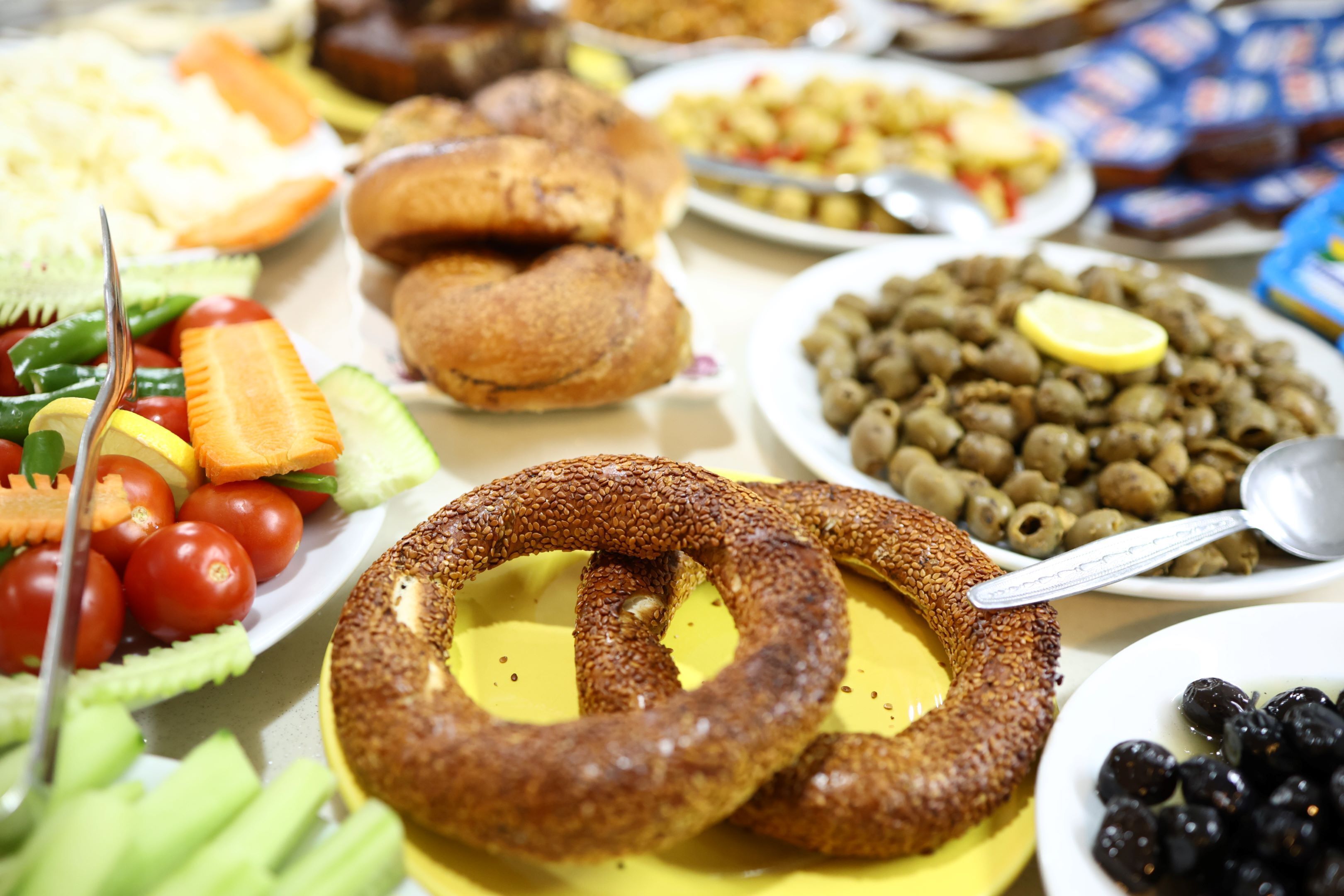 A table with various food items including olives, bread, and vegetables.