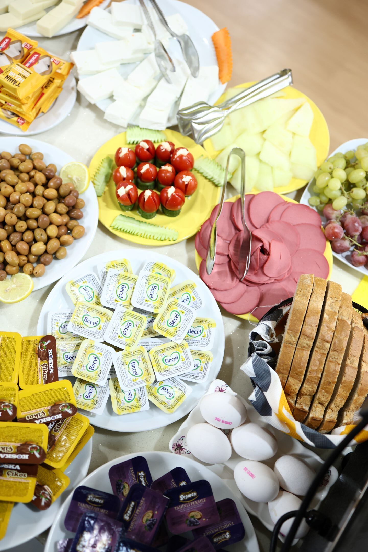 A table with various food items including cheese, eggs, and bread.