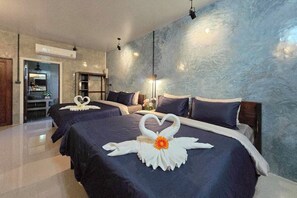 A hotel room with two beds, each adorned with a swan-shaped towel arrangement. - Smilingface Guesthouse (Sukhothai)