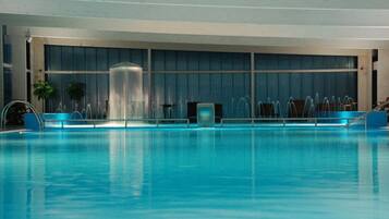 Relax by the pool, surrounded by natural light and views of the surrounding area.