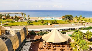 A resort with a pool, outdoor seating, and a view of the ocean. - Grand Akca Hotel (Gazipasa)