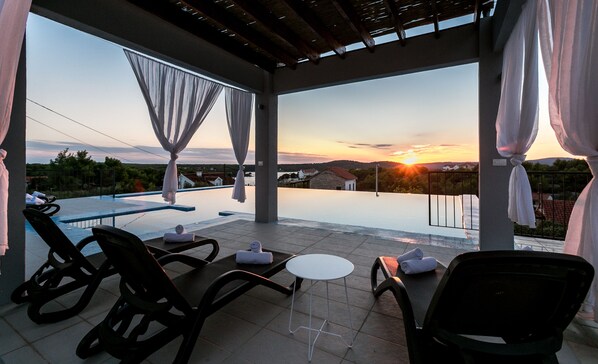 Outdoor pool, open 6:00 AM to 10:00 PM, pool umbrellas, sun loungers