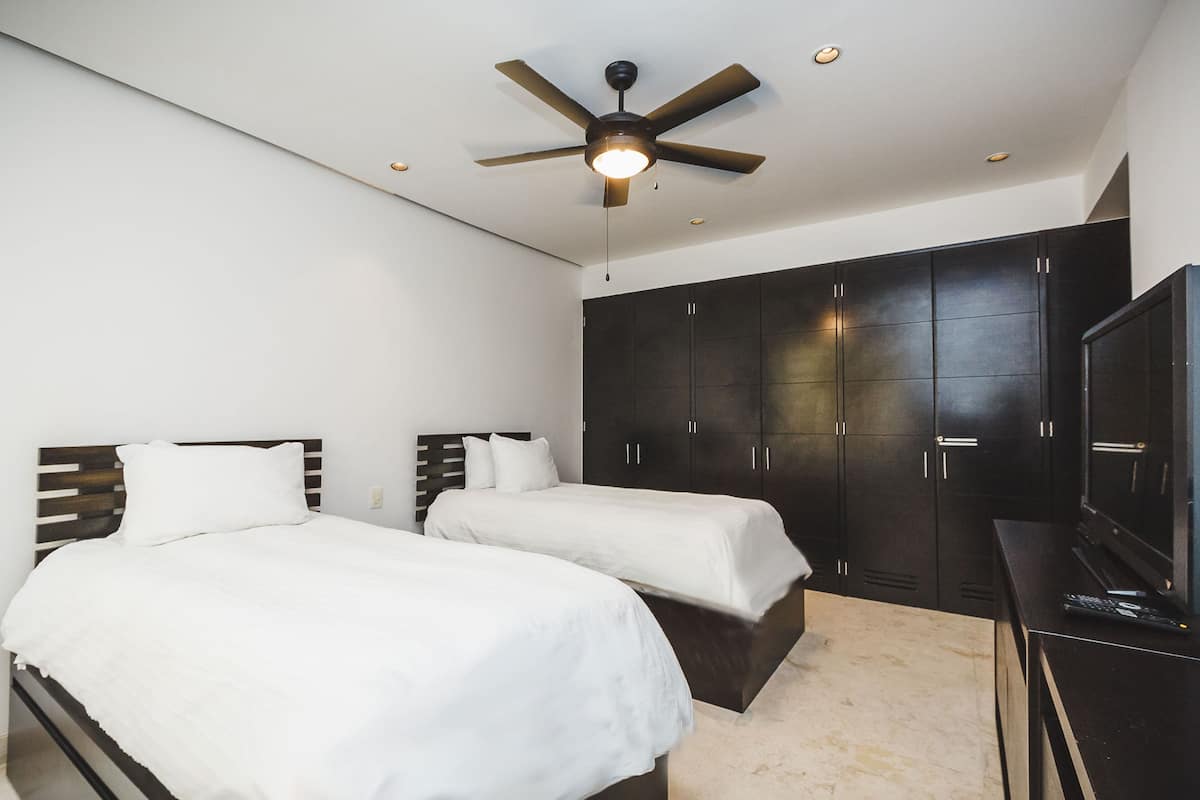 Exclusive Condo, 2 Bedrooms, Pool Access, Beachside | 2 bedrooms, in-room safe, iron/ironing board, cribs/infant beds