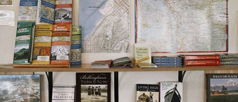 A display of books and maps, including titles like 'Bellingham Then & Now' and 'Olympic Peninsula'.