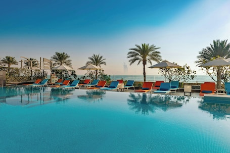 Outdoor pool, pool umbrellas, pool loungers. Aloft by Marriott Palm Jumeirah