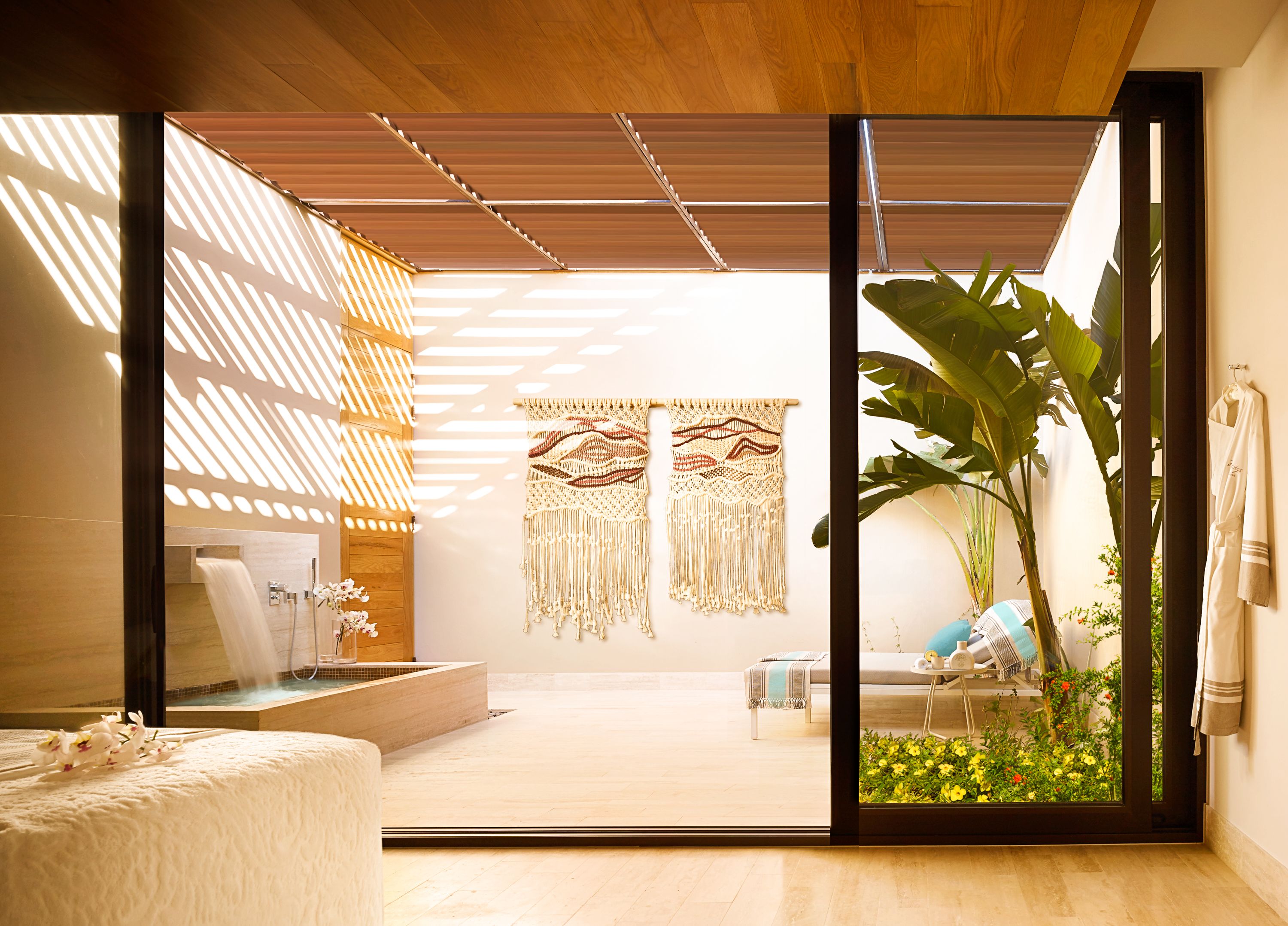 A modern bathroom with a wooden ceiling, a large mirror, and a shower area.
