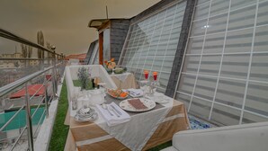A dining area with a table set for two, featuring a variety of dishes and drinks. - Rose Petal (Srinagar)
