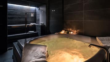 Relax in a spacious heated tub, surrounded by a sleek, contemporary design and a cozy seating area.