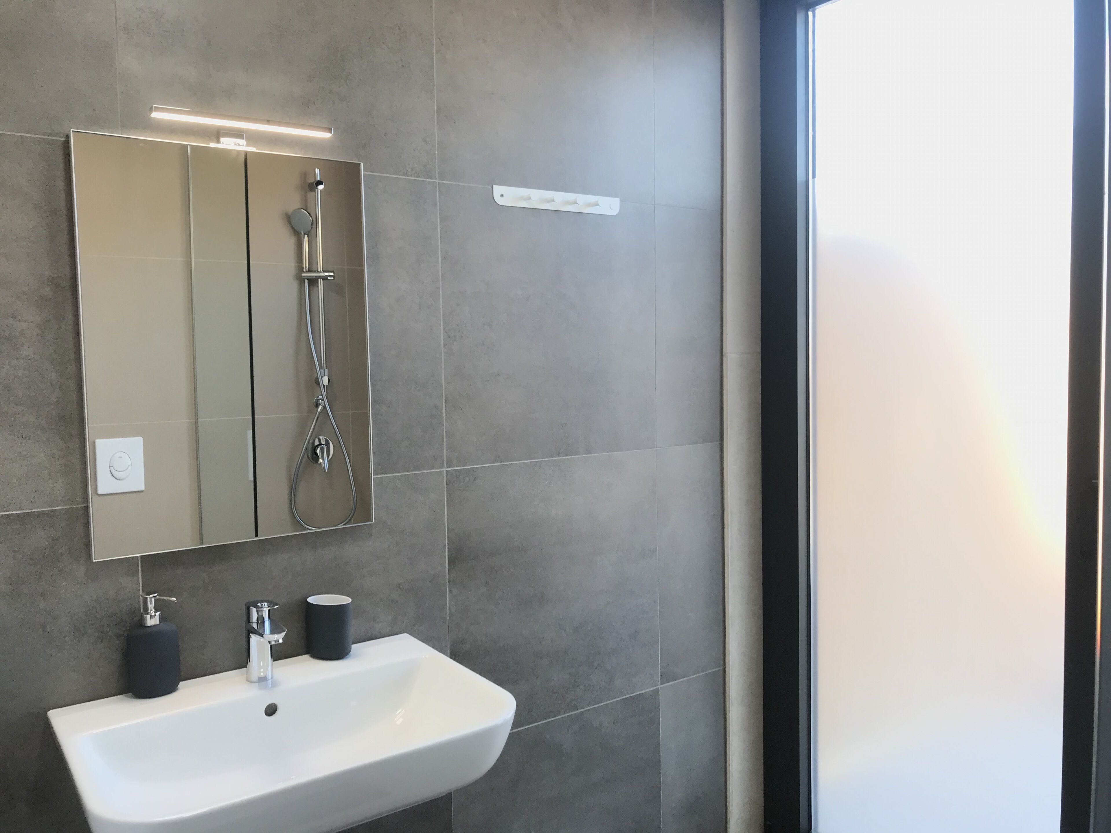 panoramic room, city view | bathroom | shower, hair dryer, slippers, towels