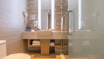 A modern bathroom with a toilet, sink, and shower area.