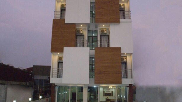 A multi-story building with a prominent 'UD' sign, featuring a modern architectural design with mixed materials. - UD Residence (Udon Thani)