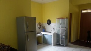 A compact kitchen with a refrigerator, a sink, and a cabinet.