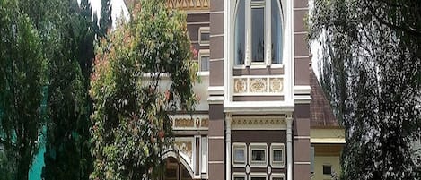 A historic building with a prominent arched window and decorative facade.