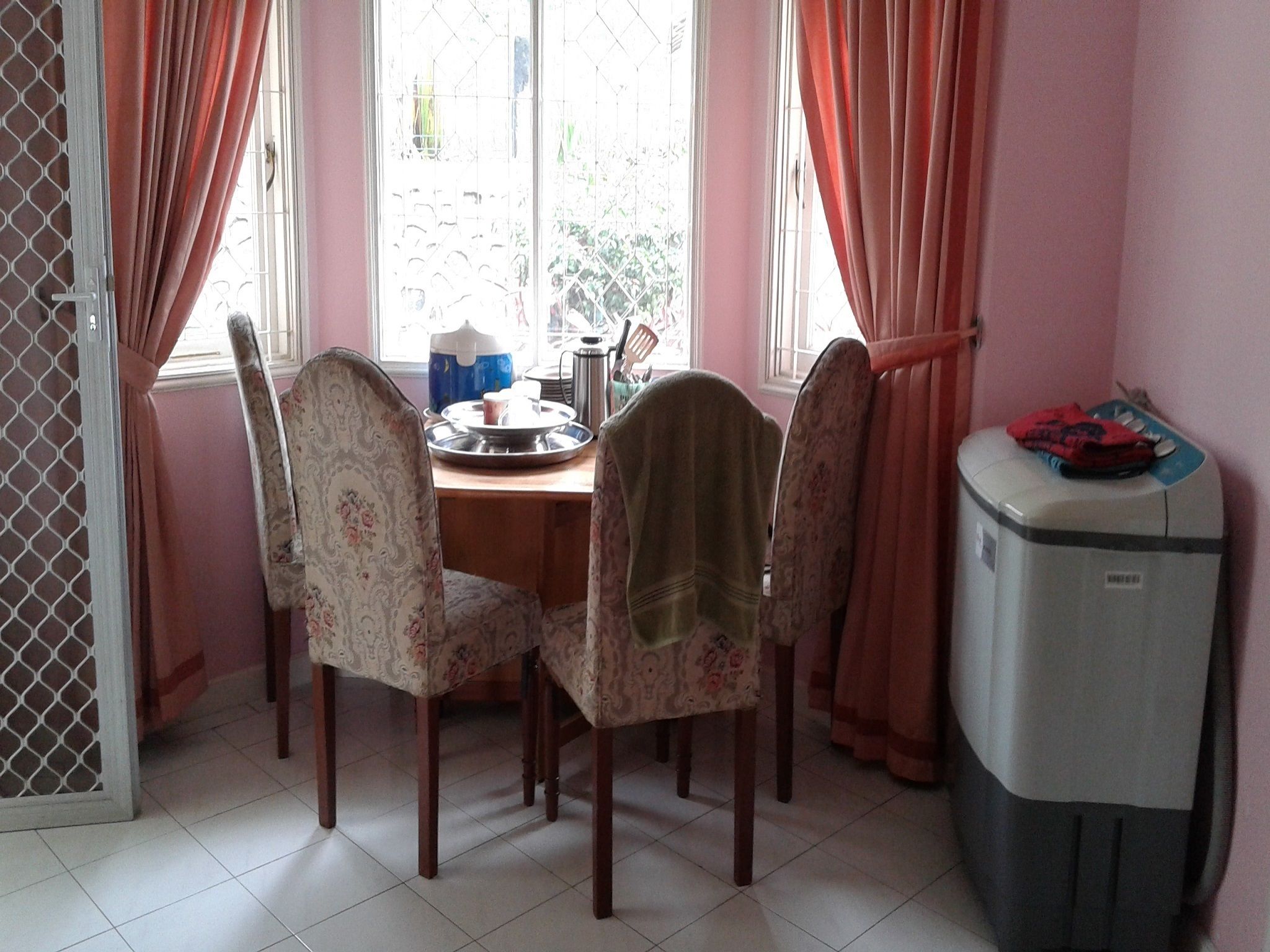 A dining area with a table, chairs, and a water dispenser.