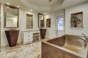 A spacious bathroom with a large bathtub, two sinks, and multiple mirrors. - Cassina Palms (Hilton Head Island)