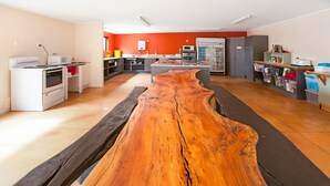 Eine moderne Küche mit Kochinsel, weißen Geräten und einer hölzernen Bank.