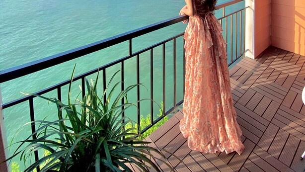 A balcony with a view of a cityscape and water. - Le Pont Bungalow Hostel (Hai Phong)