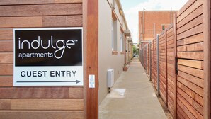 A guest entry sign for Indulge Apartments. - Indulge Apartments -The Urban Collection (Mildura)