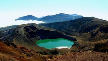 A crater lake surrounded by rugged mountains.
