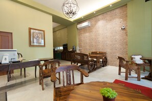 A room with a brick wall, wooden furniture, a chandelier, and a computer on a desk. - Hualien 5FM Homestay - Xinyi (Hualien City)