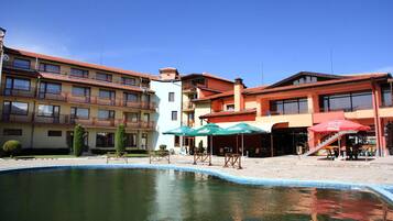 Seasonal outdoor pool, open 7:30 AM to 7:30 PM, pool umbrellas