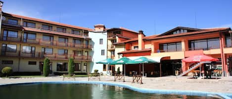 Seasonal outdoor pool, open 7:30 AM to 7:30 PM, pool umbrellas