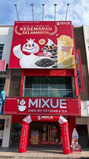 A storefront with a prominent red and white sign advertising ice cream and tea. - Island Homestay (Pangkor Island)