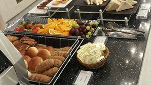 A buffet with various food items including fruits, pastries, and sandwiches. - Incheon Airport Transit Hotel - Terminal 2 (Incheon)