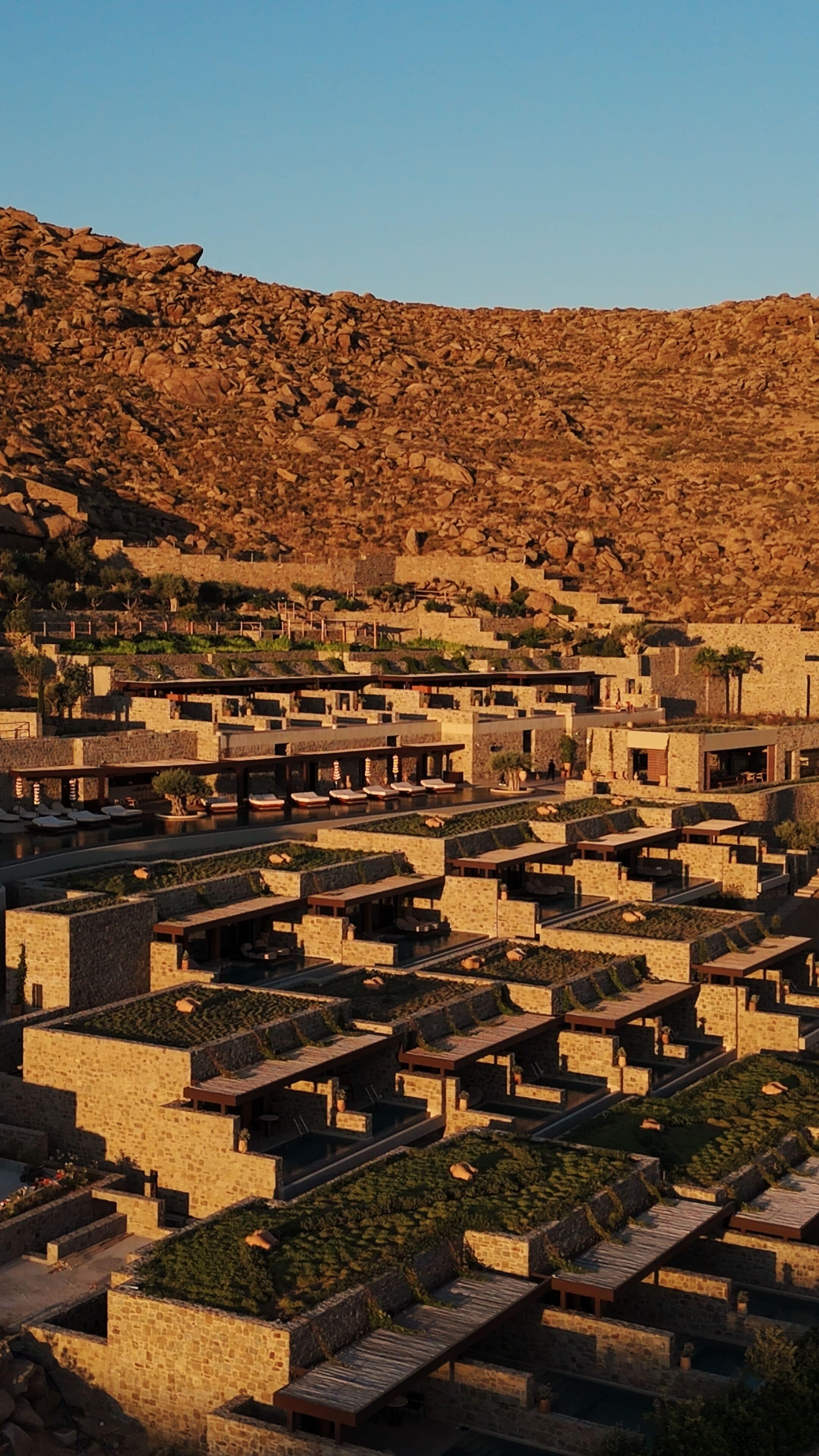 A terraced building complex with multiple levels and outdoor seating areas.