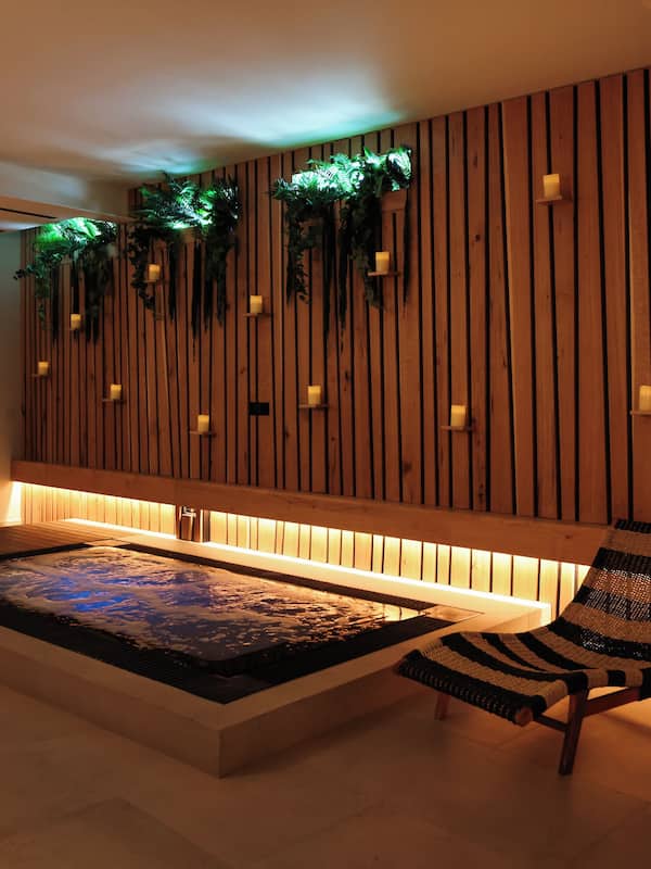 Relax in a spacious room with a heated floor area, lounge chairs, and recessed lighting.