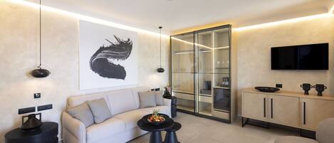 A modern living room with a sofa, coffee table, and a glass cabinet.