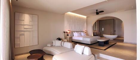 A modern bedroom with a large bed, a sofa, and a seating area.