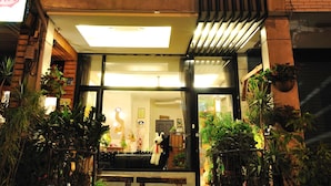 A building with a neon sign and a visible entrance. - Sweet Heart Hostel (Hualien City)