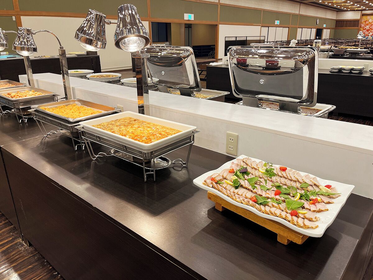 A buffet setup with various food items and serving stations.