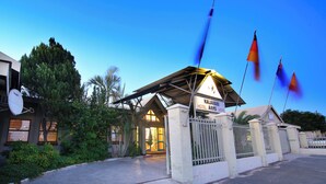 A hotel entrance with a sign reading "Kalahari Hotel Arms Hotel". - Kalahari Arms Hotel (Ghanzi)