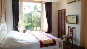 A neatly made bed with a white and red bedspread, a wooden chair with a floral cushion, and a large window with curtains. - Yun Shan Shui Yi Cui Hsuan Resort (Shoufeng)