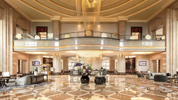 A spacious lobby with a grand chandelier, a reception desk, and a balcony with decorative railings. - Chateau Star River Shaanxi (Xianyang)