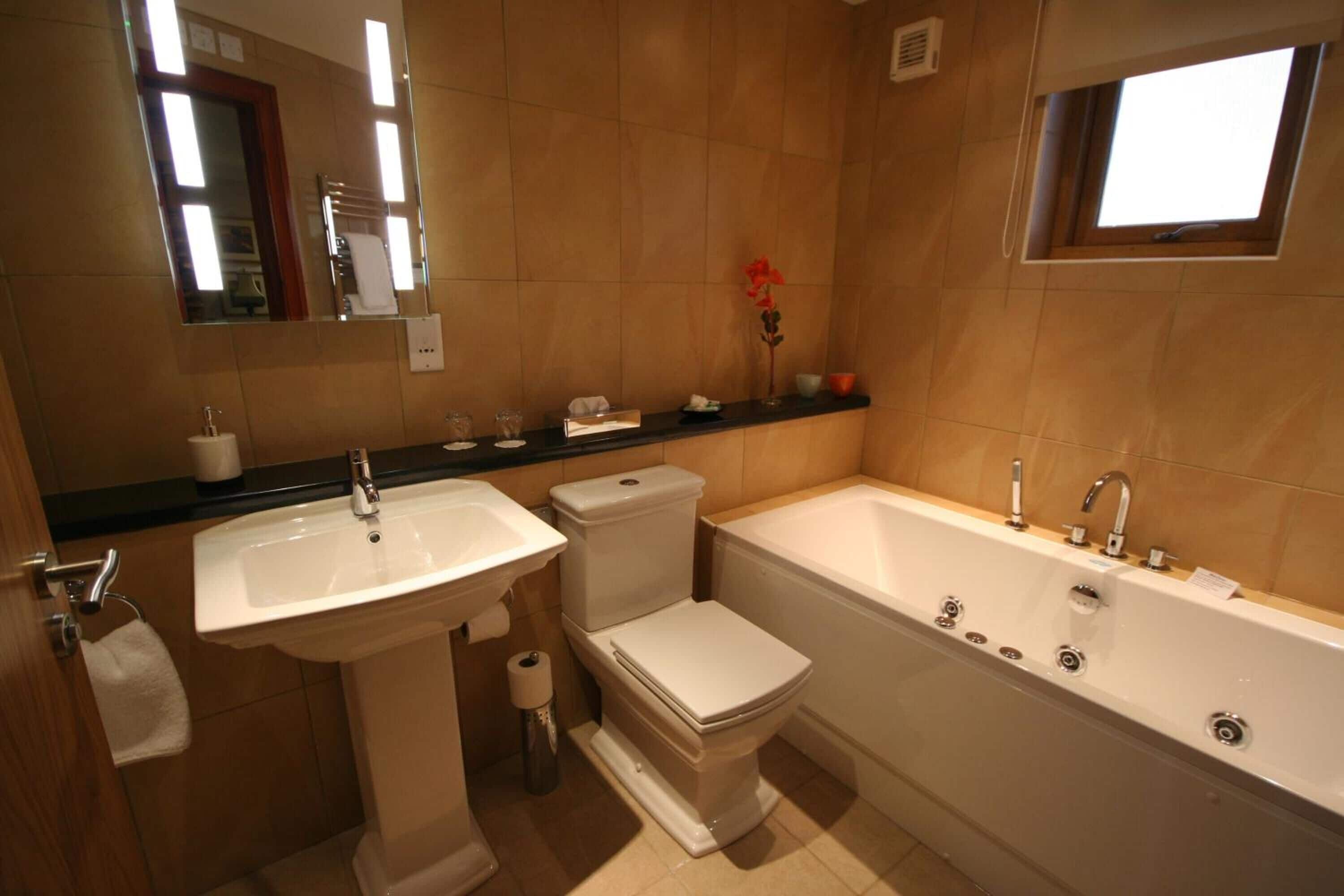 A bathroom with a sink, toilet, and bathtub.
