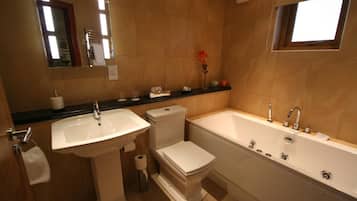 A bathroom with a sink, toilet, and bathtub.