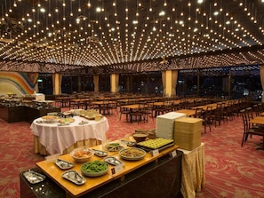 A banquet hall with multiple round tables covered with white tablecloths, arranged in rows. - Atami Kinjokan (Atami)