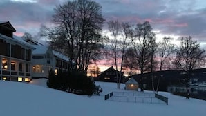A snow-covered landscape with buildings and trees.