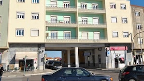 A multi-story building with a flat facade, balconies on the upper floors, and a ground-level entrance. - Tagus Host (Santarém)