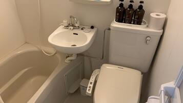 A bathroom with a bathtub, a sink, and a toilet.
