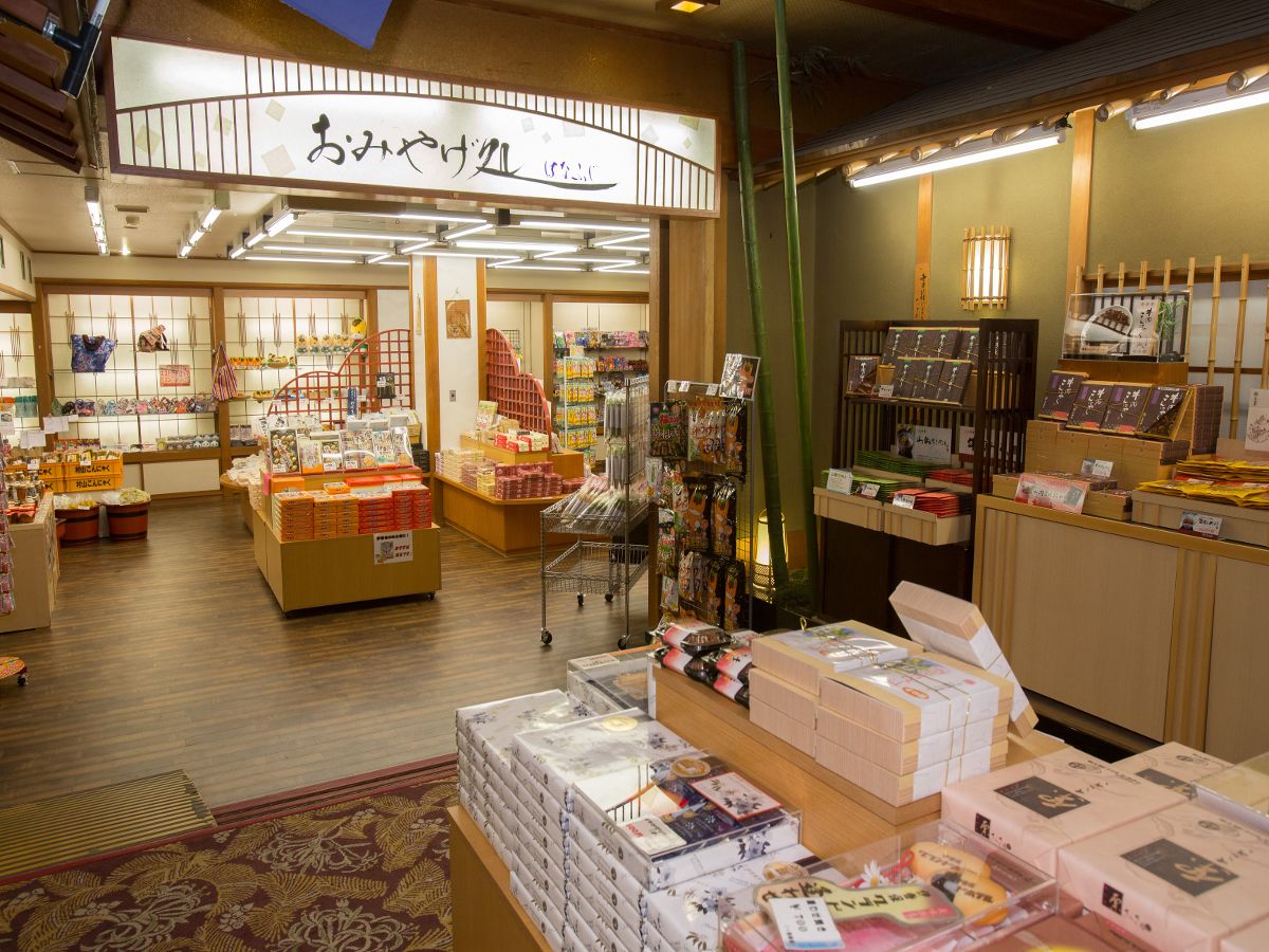 A traditional Japanese bookstore with wooden floors and shelves filled with books and magazines.