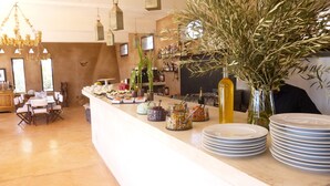 A buffet setup with various food items and a bar area with bottles. - La Parenthese de Marrakech (Tameslouht)