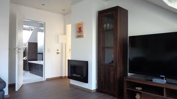 Exclusive Apartment, 1 Bedroom | Living room | Flat-screen TV, fireplace